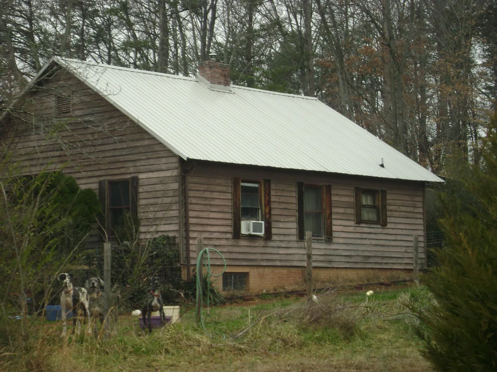 White metal roof on an old wood sided farmhouse, from a Metal Roof Installation job in Newell